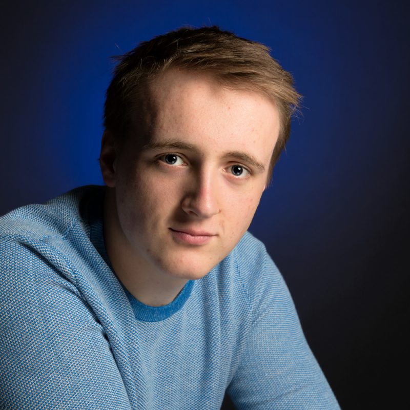 Male on dark blue background