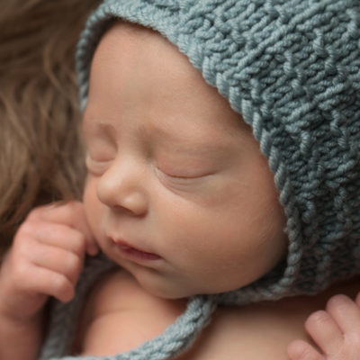 newborn with teal bonnet