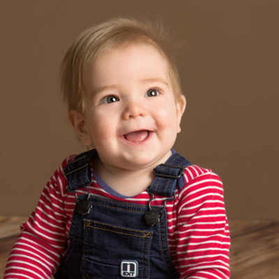 Smiling baby in dungarees