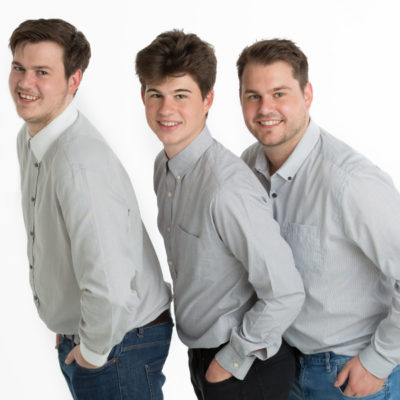 Three male siblings on white background