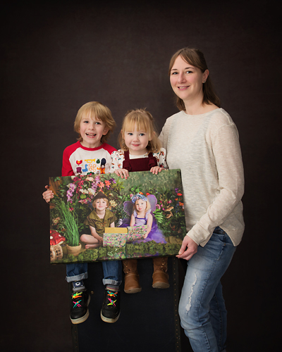 Photograph of 2017 Fairy Experience winners collecting their wall canvas