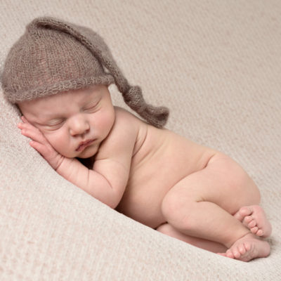 Newborn baby with Wee Willy Winkie hat