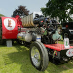 photos of a tractor dragging engine