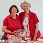 Two ladies serving strawberries and cream