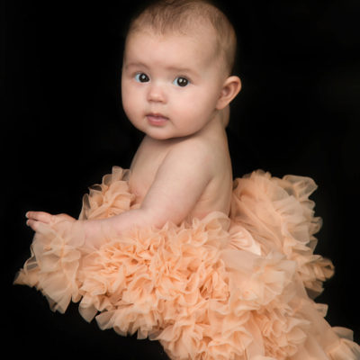 Baby in tutu looking over her shoulder