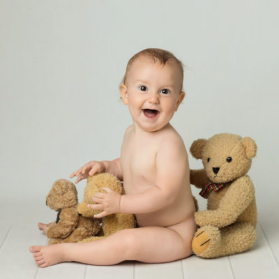 laughing baby with teddies