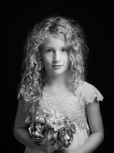 Little girl with lacy dress and tousled hair