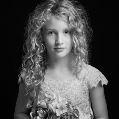 Little girl with lacy dress and tousled hair