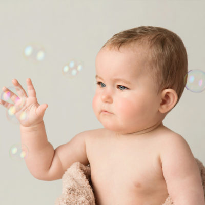 Baby catching bubbles